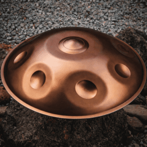 Bronze handpan on rocky surface